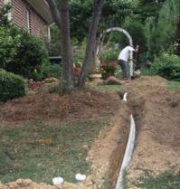 a new sprinkler line being laid by an irrigation contractor