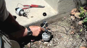 Timm is adjusting the valve on a sprinkler system in Woodinville